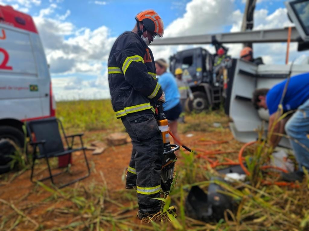 Carreta tomba em serra e motorista fica preso às ferragens